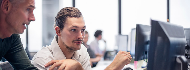 Two men with computer screen