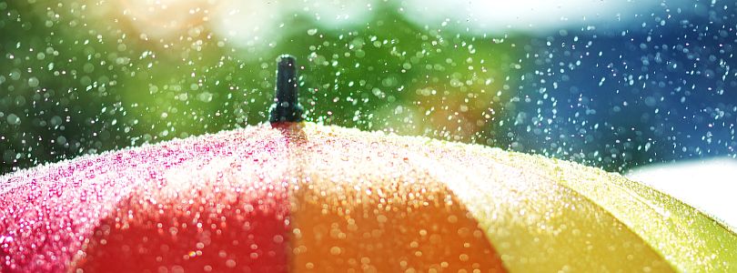 Rain splashing on a colourful umbrella